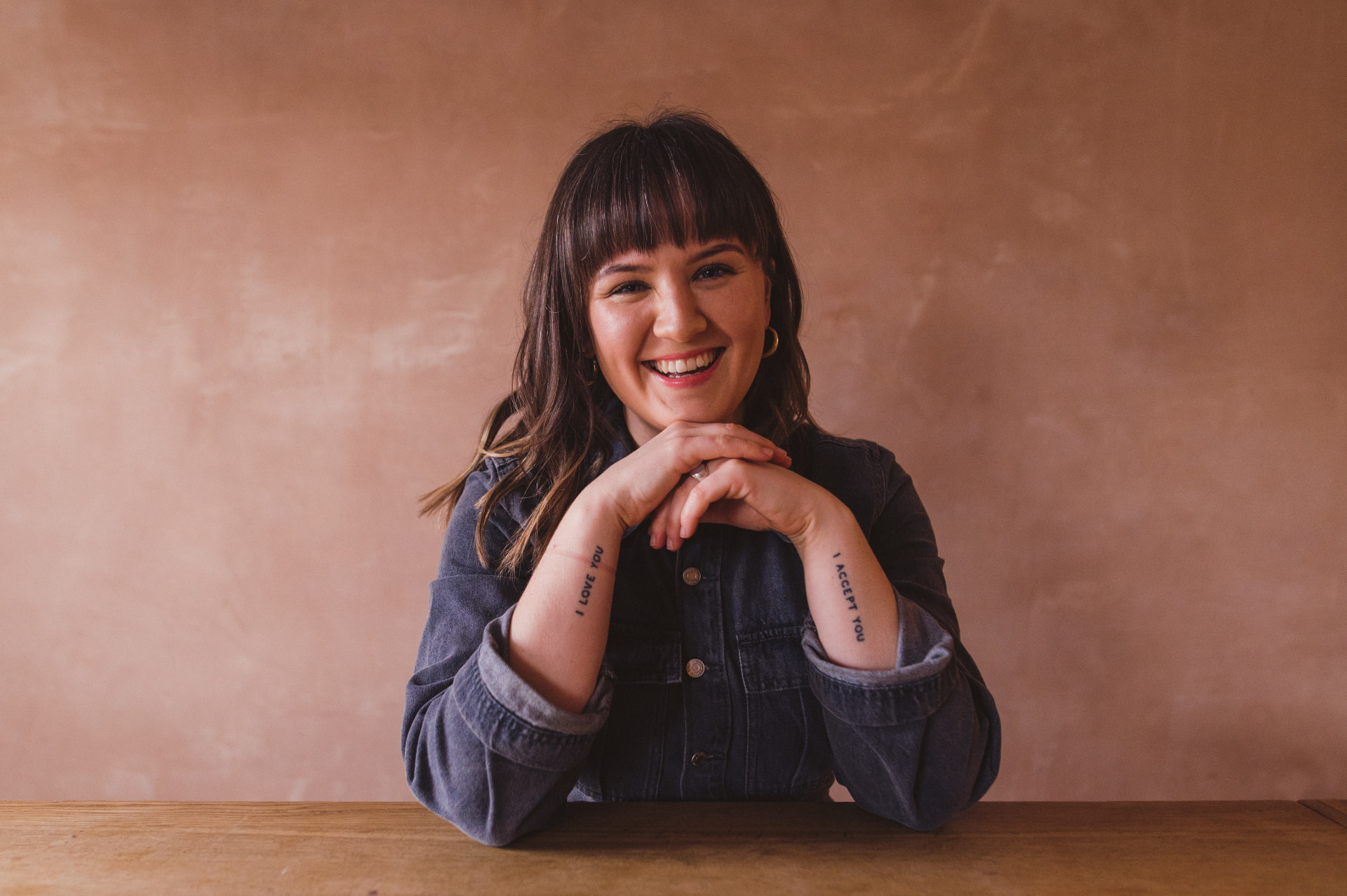 Alex Bottomley smiling with chin resting on her hands
